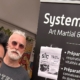 Trois membres du Systema Centre au stand du club, place du Martroi, devant le kakémono présentant l’art martial et la self-défense